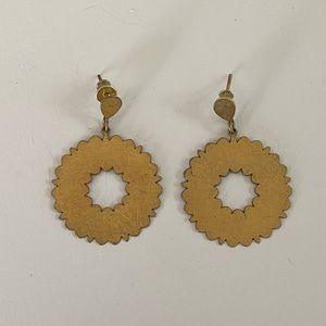 Matte gold laser cut hoop earrings on a post